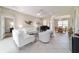 Open living space with tile floors, white sofas, a piano, and plenty of natural light at 13146 Se 91St Court Rd, Summerfield, FL 34491