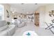 Spacious living room adjacent to kitchen, with neutral tones, and plenty of natural light at 13146 Se 91St Court Rd, Summerfield, FL 34491