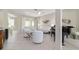 Bright living room with white seating, a piano, tile floors, and a ceiling fan at 13146 Se 91St Court Rd, Summerfield, FL 34491