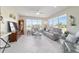 Inviting living room with tile floors, ceiling fan, and large windows offering outdoor views at 13146 Se 91St Court Rd, Summerfield, FL 34491