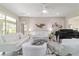 Bright living room with white seating, a piano, tile floors, and a ceiling fan at 13146 Se 91St Court Rd, Summerfield, FL 34491