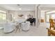 Spacious living room with elegant decor, tile flooring, and seamless access to dining area at 13146 Se 91St Court Rd, Summerfield, FL 34491