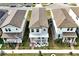 Aerial view showcasing a gray two-story home with a covered front porch and walkway flanked by plants at 140 S Zuni Rd, St Cloud, FL 34771