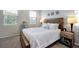 Calm main bedroom featuring a comfortable bed, window and coordinated furnishings at 140 S Zuni Rd, St Cloud, FL 34771