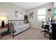 Bright bedroom featuring a daybed, desk, and window for a relaxing retreat at 140 S Zuni Rd, St Cloud, FL 34771