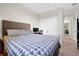 This bedroom has blue triangle bedding and features a work desk and double door closet at 140 S Zuni Rd, St Cloud, FL 34771