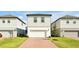 New construction, two-story home features a white garage door and sidewalk to the front door at 140 S Zuni Rd, St Cloud, FL 34771