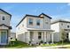 Stylish two-story home with modern design, landscaped yard, and inviting front porch at 140 S Zuni Rd, St Cloud, FL 34771