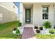 Inviting front entrance with a well-manicured garden and brick path leading to the home at 140 S Zuni Rd, St Cloud, FL 34771