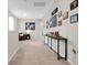 Upstairs hallway with console table, photo gallery, and cozy seating area at 140 S Zuni Rd, St Cloud, FL 34771