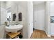Modern bathroom with a stylish vessel sink, wood-look flooring, and a conveniently located adjacent doorway at 140 S Zuni Rd, St Cloud, FL 34771