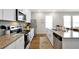 Bright kitchen with stainless appliances, granite countertops, and ample storage space at 140 S Zuni Rd, St Cloud, FL 34771