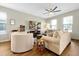 Comfortable living room with neutral colors, ceiling fan, and wood-look tile flooring at 140 S Zuni Rd, St Cloud, FL 34771
