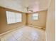 View of a bedroom featuring tile floors, a ceiling fan, and two windows at 15747 Old Highway 50, Clermont, FL 34711