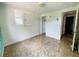 View of a bedroom featuring marble-style floors and a door to the hallway at 15747 Old Highway 50, Clermont, FL 34711