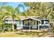 Charming single-story home with a well-manicured lawn and a beautiful palm tree in the front yard at 15747 Old Highway 50, Clermont, FL 34711