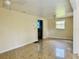 View of the living room with a ceiling light and a hallway leading to another room and marble-style floors at 15747 Old Highway 50, Clermont, FL 34711