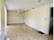 View of the living room with a ceiling fan and a hallway leading to another room and marble-style floors at 15747 Old Highway 50, Clermont, FL 34711