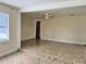 View of the living room with a ceiling fan and a hallway leading to another room and marble-style floors at 15747 Old Highway 50, Clermont, FL 34711
