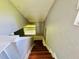 View down a well-lit staircase with natural light and hardwood steps at 15747 Old Highway 50, Clermont, FL 34711