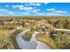 An aerial view of a single-Gathering home on a tree-lined lot with a long driveway and a well-maintained lawn at 1603 Brookstone Ln, Fruitland Park, FL 34731