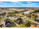 Aerial view of a neighborhood featuring a pond and green pastures, and the homes have well-manicured lawns at 1603 Brookstone Ln, Fruitland Park, FL 34731