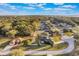 Aerial view of a home on a tree-lined lot in a quiet neighborhood, with a large front and backyard at 1603 Brookstone Ln, Fruitland Park, FL 34731