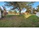 Spacious backyard with lush lawn and mature trees at 1603 Brookstone Ln, Fruitland Park, FL 34731