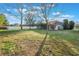 Grassy backyard with mature trees offers a private outdoor space at 1603 Brookstone Ln, Fruitland Park, FL 34731