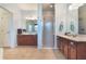Bright bathroom with double vanities, a glass-enclosed shower, and tile flooring at 1603 Brookstone Ln, Fruitland Park, FL 34731