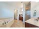 Spacious bathroom with tub, shower and double vanity featuring marble countertop at 1603 Brookstone Ln, Fruitland Park, FL 34731