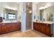 Bright bathroom featuring tile flooring, double sinks, and a glass-enclosed shower at 1603 Brookstone Ln, Fruitland Park, FL 34731