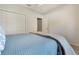 Cozy bedroom featuring a plush bed, closet, and an open doorway at 1603 Brookstone Ln, Fruitland Park, FL 34731