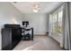 Neutral-toned bedroom with a ceiling fan, large window, and carpet flooring, perfect for relaxation and comfort at 1603 Brookstone Ln, Fruitland Park, FL 34731