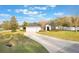 Inviting home with a two-car garage, a curved driveway, and a manicured lawn, creating a welcoming curb appeal at 1603 Brookstone Ln, Fruitland Park, FL 34731