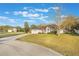 Residential house with a well-kept lawn and landscaping, complemented by a long driveway and a two-car garage at 1603 Brookstone Ln, Fruitland Park, FL 34731