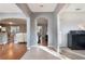 Open hallway with views into multiple living spaces, featuring a mix of tile and hardwood flooring and neutral wall colors at 1603 Brookstone Ln, Fruitland Park, FL 34731