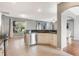 Open-concept kitchen with breakfast bar, stainless steel appliances, and tile floors at 1603 Brookstone Ln, Fruitland Park, FL 34731