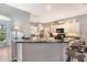 Open kitchen with breakfast bar and modern white cabinetry at 1603 Brookstone Ln, Fruitland Park, FL 34731