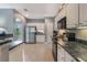 Spacious kitchen featuring white cabinetry, stainless steel appliances and modern design at 1603 Brookstone Ln, Fruitland Park, FL 34731