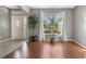 Bright living room with hardwood floors, a large window with natural light, and a view of the front door at 1603 Brookstone Ln, Fruitland Park, FL 34731