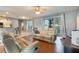 Comfortable living room with hardwood floors, a ceiling fan, and sliding glass doors leading to the backyard at 1603 Brookstone Ln, Fruitland Park, FL 34731