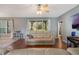Bright living room featuring hardwood floors and a comfortable reclining sofa set at 1603 Brookstone Ln, Fruitland Park, FL 34731