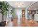 Open-concept living room with hardwood floors, a large window with natural light, and seamless transitions to other rooms at 1603 Brookstone Ln, Fruitland Park, FL 34731