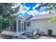 Backyard patio with seating and an enclosed sunroom at 1617 Lakewood Dr, The Villages, FL 32162