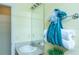 Bathroom featuring a sink, large mirror, and turquoise towels at 1617 Lakewood Dr, The Villages, FL 32162