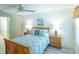 Bright bedroom with a wooden bed frame and coastal decor at 1617 Lakewood Dr, The Villages, FL 32162