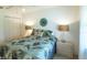 Bedroom with a queen size bed with tropical bedding at 1617 Lakewood Dr, The Villages, FL 32162