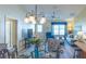 Elegant dining area with modern light fixture and stylish furniture, flowing into the living room at 1617 Lakewood Dr, The Villages, FL 32162