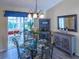 Dining space with a glass table and chairs, leading to the outdoor patio at 1617 Lakewood Dr, The Villages, FL 32162